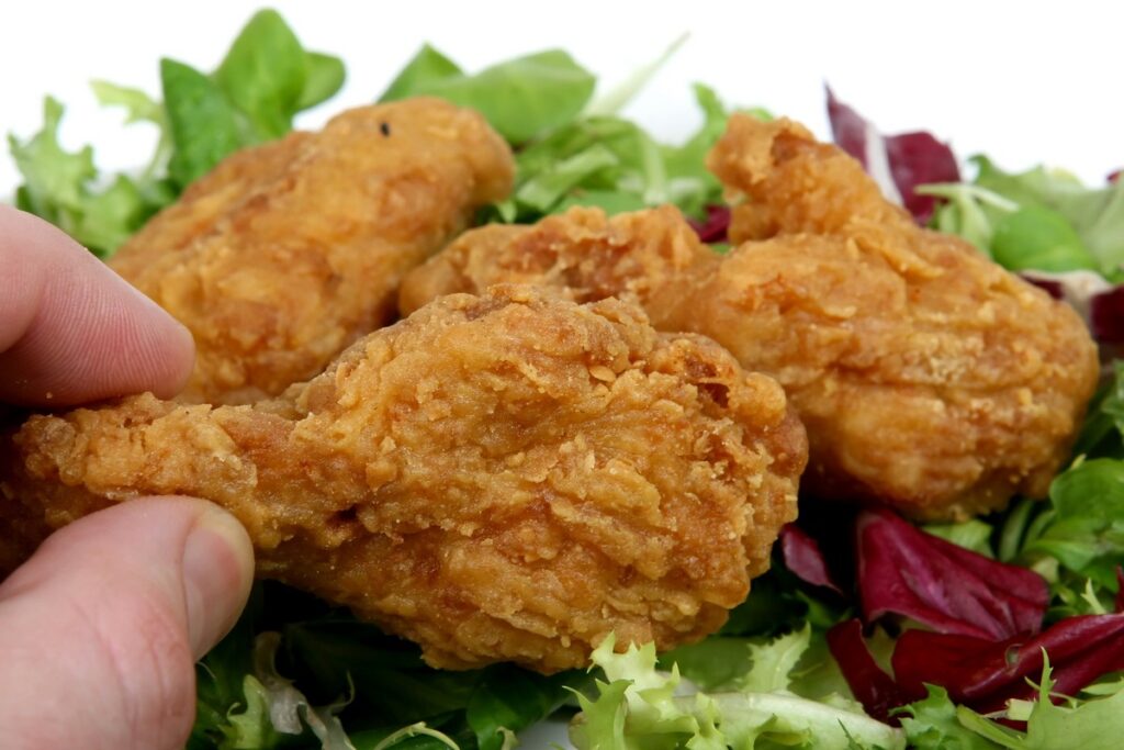 Deep fried spring chicken in golden lemon batter with salad